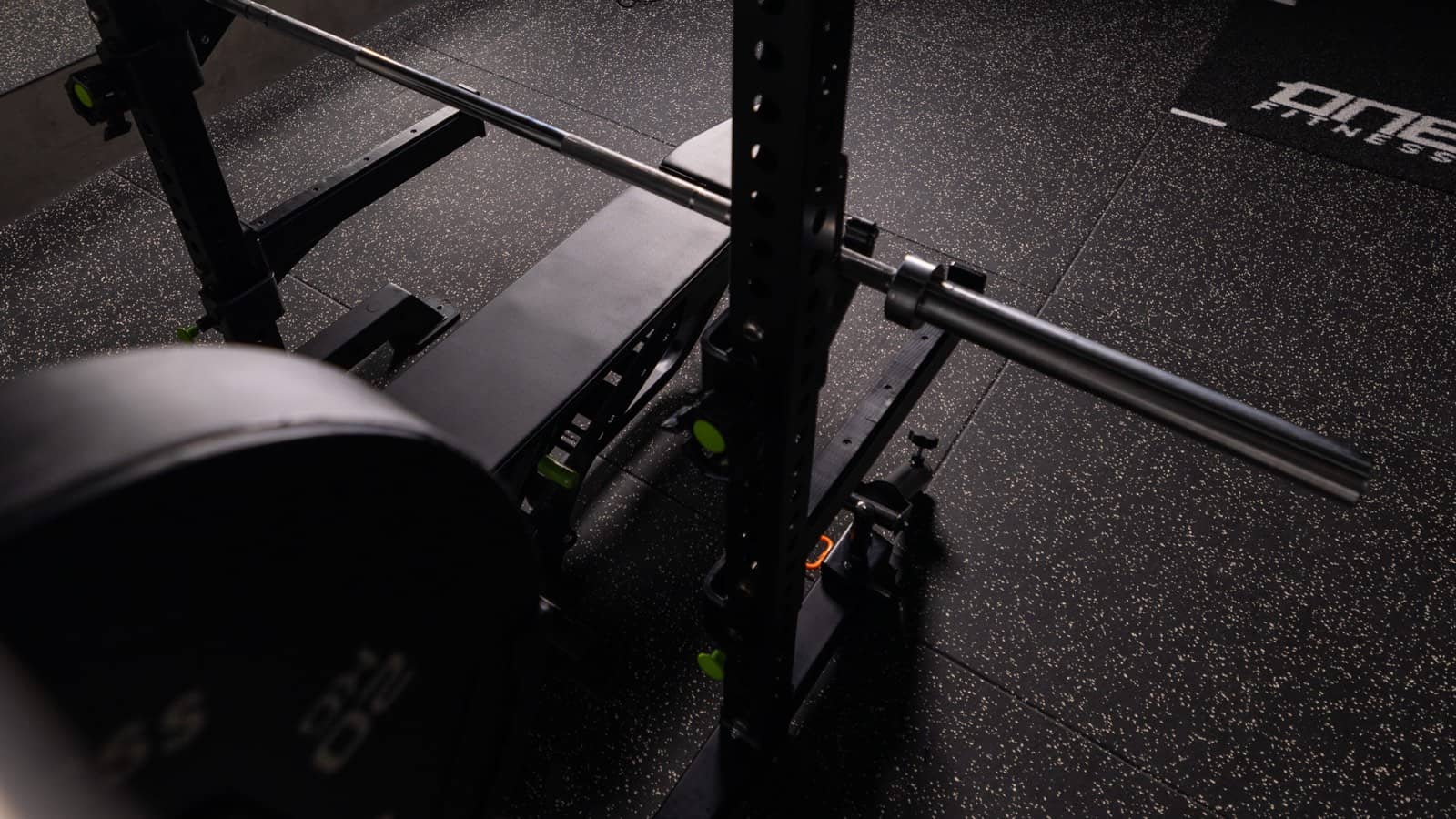 A loaded barbell resting in the squat rack